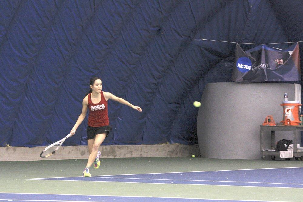 Sophomore Taylor Pena gets ready to hit the ball back to Linfield opponents