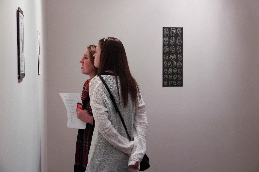 Sophomores Shayla Dougherty and Lexington Johnson enjoy the art presented in the Junior Art Show_Johnson