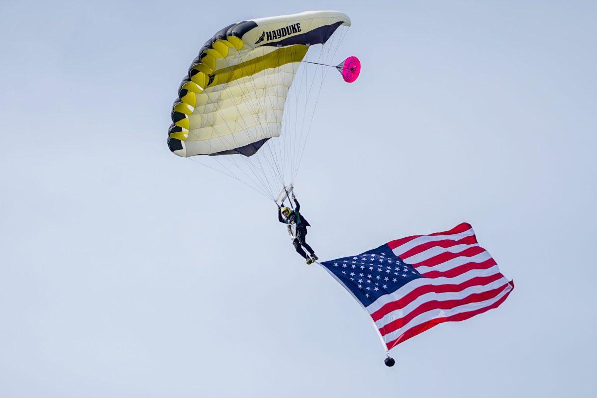 A skydiver parachutes in for a military recognition ceremony before a NCAA football game at Whitworth University against Claremont-Mudd-Scripps, Saturday, Sep. 17th 2022, in Spokane, Wash. | Caleb Flegel/The Whitworthian