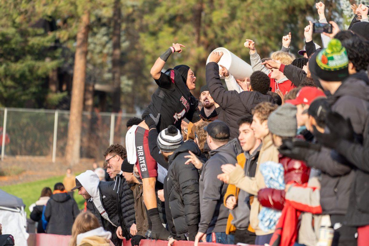 Fifth-year athlete Austin Ewing (center) celebrates with the Whitworth student section, Sat. Nov. 18, 2023, after a Whitworth University football game against Chapman University in Spokane, Wash. | Caleb Flegel/The Whitworthian 