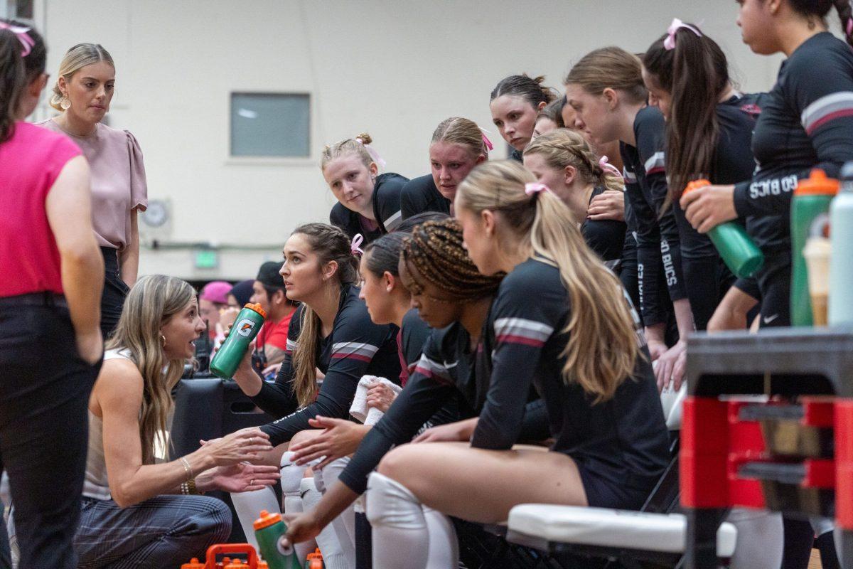 Volleyball head coach Kati Bodecker addresses the Whitworth University volleyball team during a timeout at a NCAA volleyball game against George Fox University, Oct. 21, 2023, in Spokane, Wash. | Caleb Flegel/The Whitworthian 