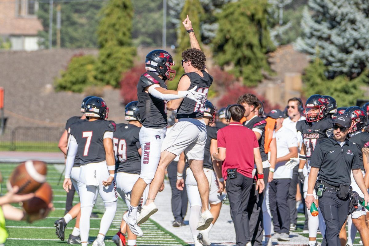 Whitworth player Dawson Tobeck (left) celebrates with Cameron Sheley (right) after a touchdown during an NCAA football game against Willamette University, Saturday, Oct. 12, 2024, in Spokane, Wash. | Caleb Flegel/The Whitworthian