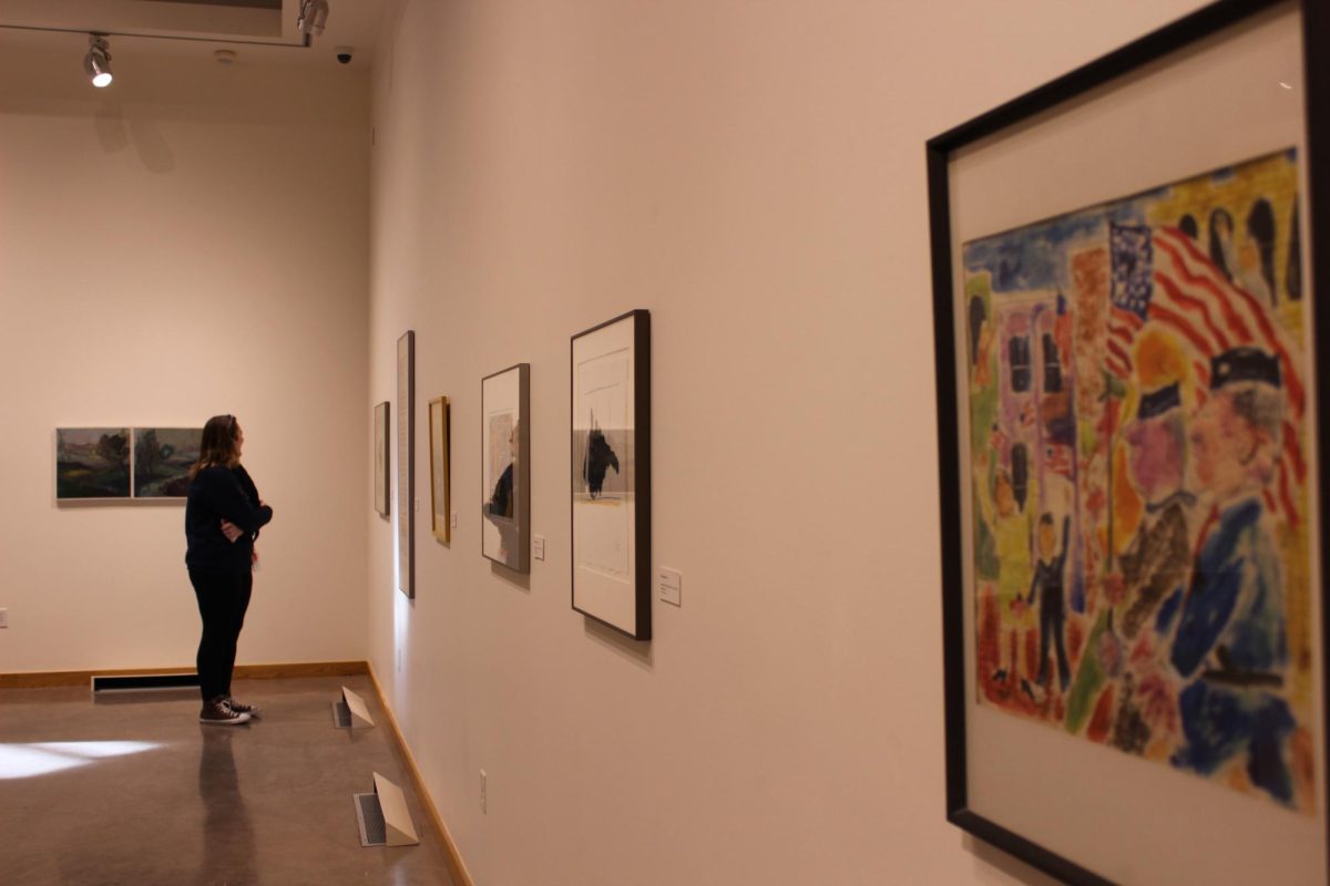 Ryann Bunch admiring the Provocative Beauty Exhibition inside the Bryan Oliver Gallery at Whitworth University, Thursday, Oct. 3rd, 2024 in Spokane, Wash. | Alyssa Hammer/The Whitworthian