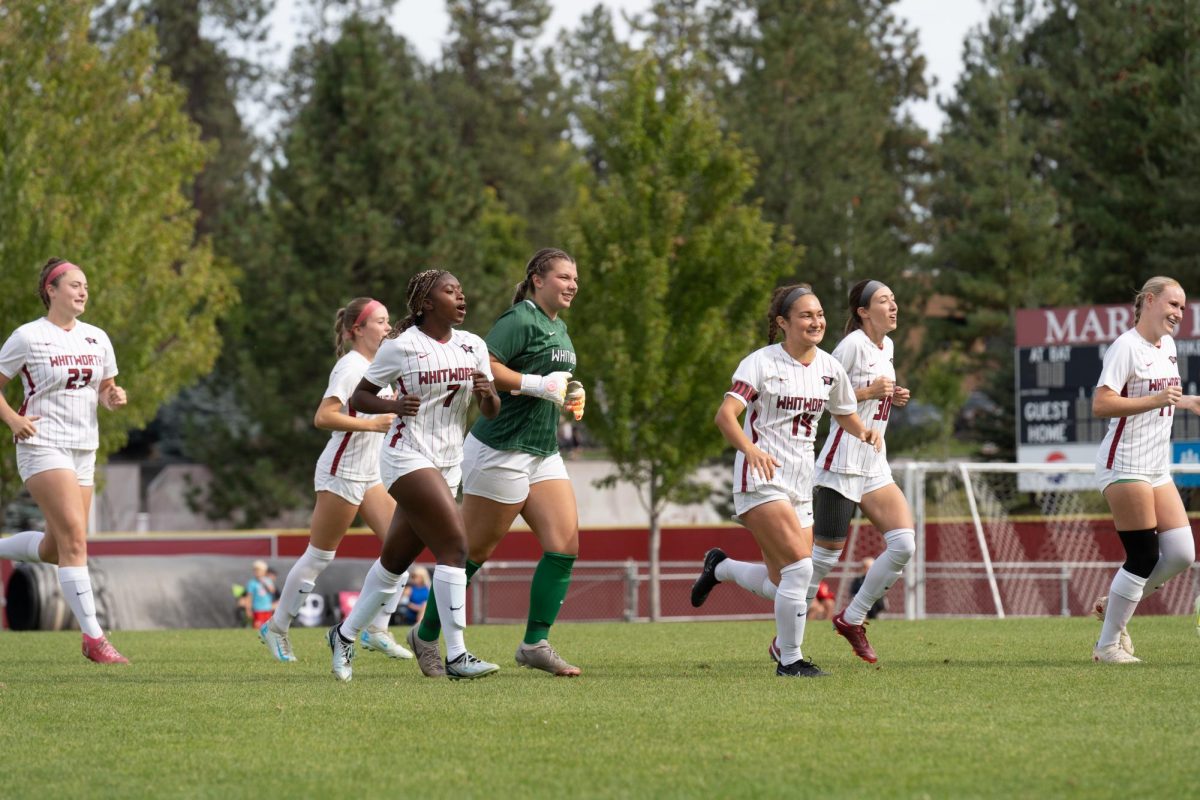 Whitworth Women’s Soccer runs to the huddle before playing George Fox University at Whitworth University, Saturday, September 21, 2024, in Spokane, Wash. | The Whitworthian/Madison Stoeckler