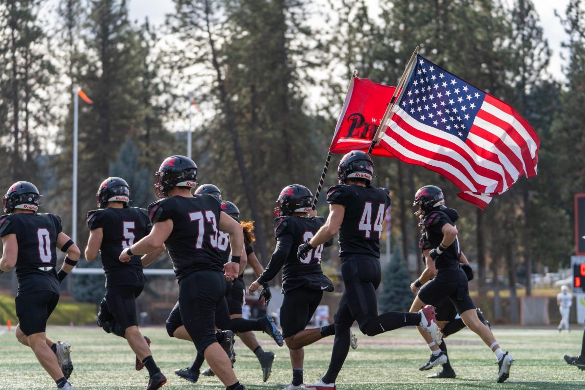 Whitworth players charge onto the field, Saturday, Nov. 16, 2024, at an NCAA football game against Linfield University at Whitworth University in Spokane, Wash. | Caleb Flegel/The Whitworthian