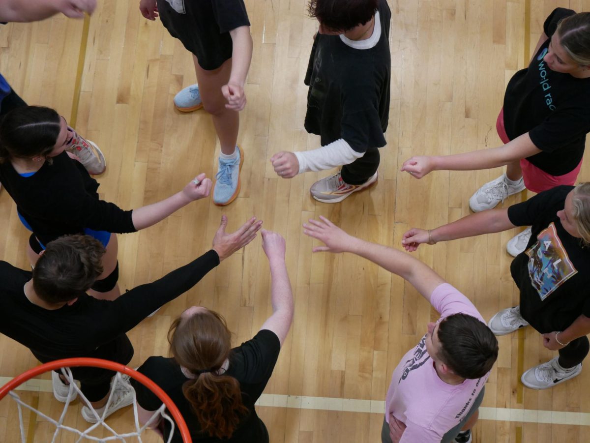 A Whitworth intramural volleyball team in a team huddle at the URec at Whitworth University, Saturday, May 4, 2024, in Spokane, Wash | Stella Fergin/The Whitworthian