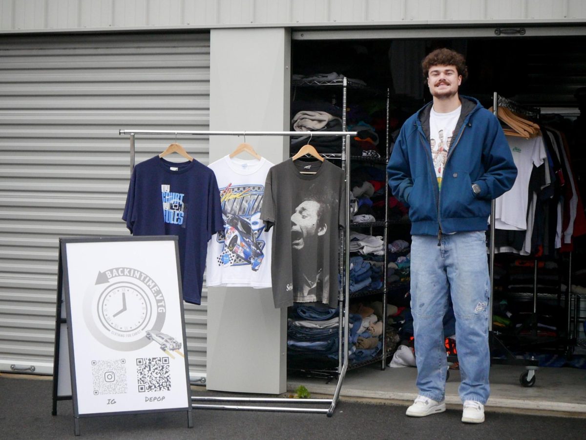 Cooper Rolfs, a Whitworth University student, poses for a picture outside his storage unit with some of his Back in Time Vintage products, Wednesday, Nov. 20, 2024, in Spokane, Wash. | The Whitworthian/Stella Fergin