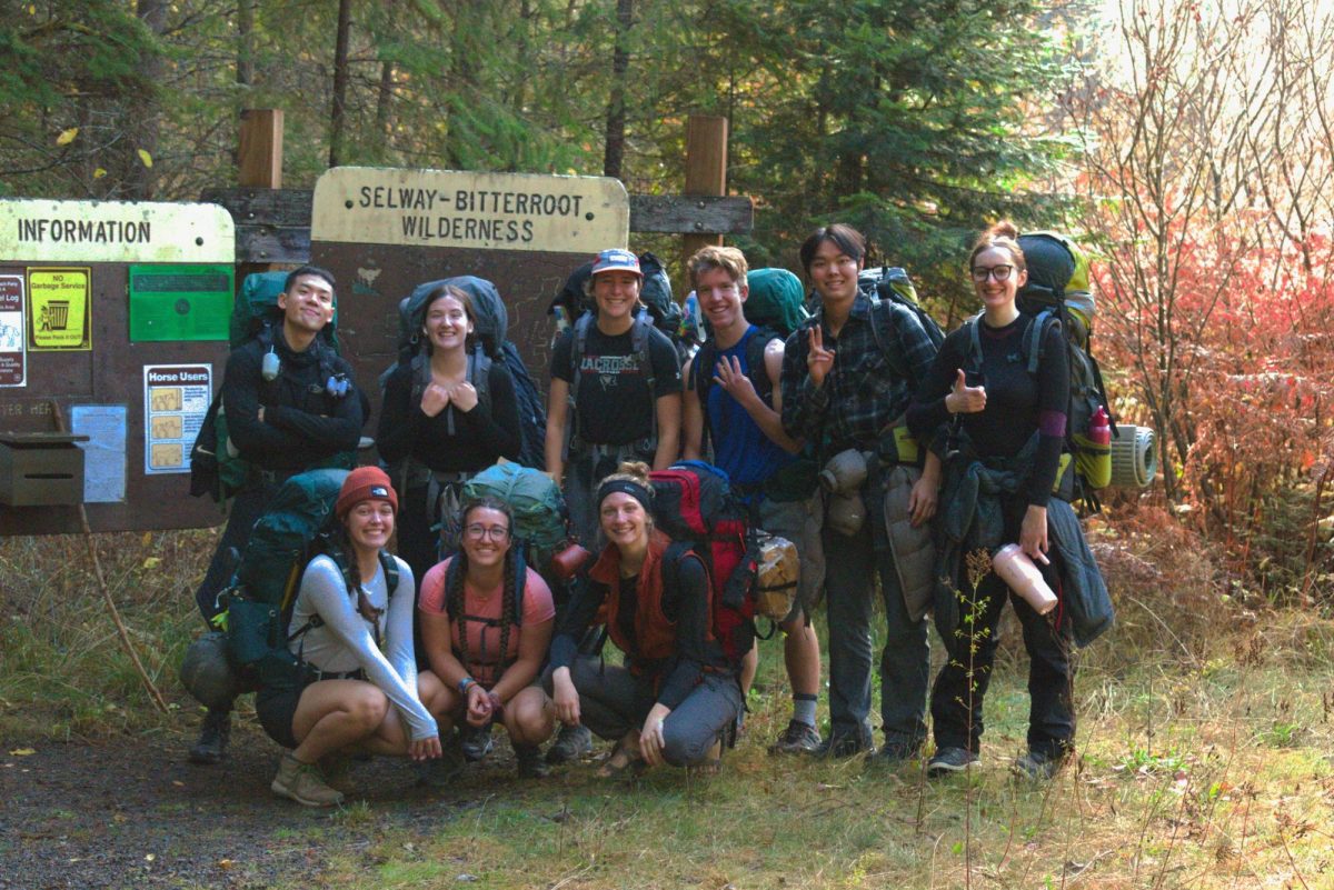 Participants posing in front of a sign during the Stanley Hot Springs trip on Saturday, Oct. 27, 2024, in the Selway-Bitterroot Wilderness, Idaho | Matt Cochran/The Whitworthian