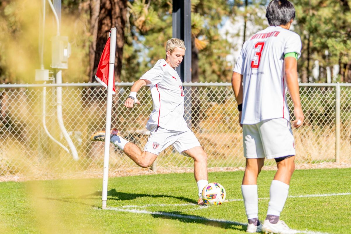 Cole Friesen (center) winds up for a corner kick, Saturday, Oct. 5, 2024, at an NCAA men's soccer game against Lewis and Clark University at Whitworth University in Spokane, Wash | Photo by Caleb Flegel, courtesy of the Whitworth Athletics Department