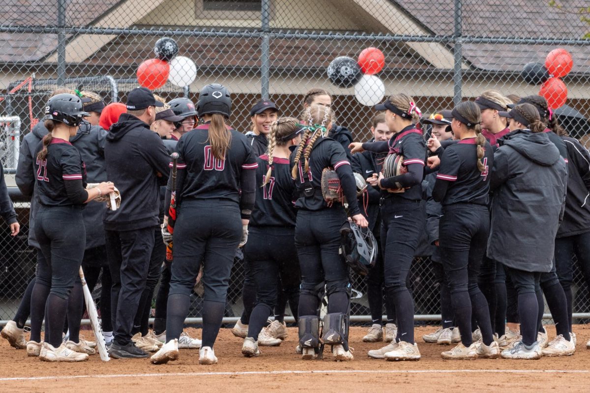 The Whitworth softball team celebrates together after a win, Sunday, May 5, 2024, at Whitworth's Marks Field in Spokane, Wash. | Photo by Caleb Flegel, courtesy of the Whitworth Athletics Department