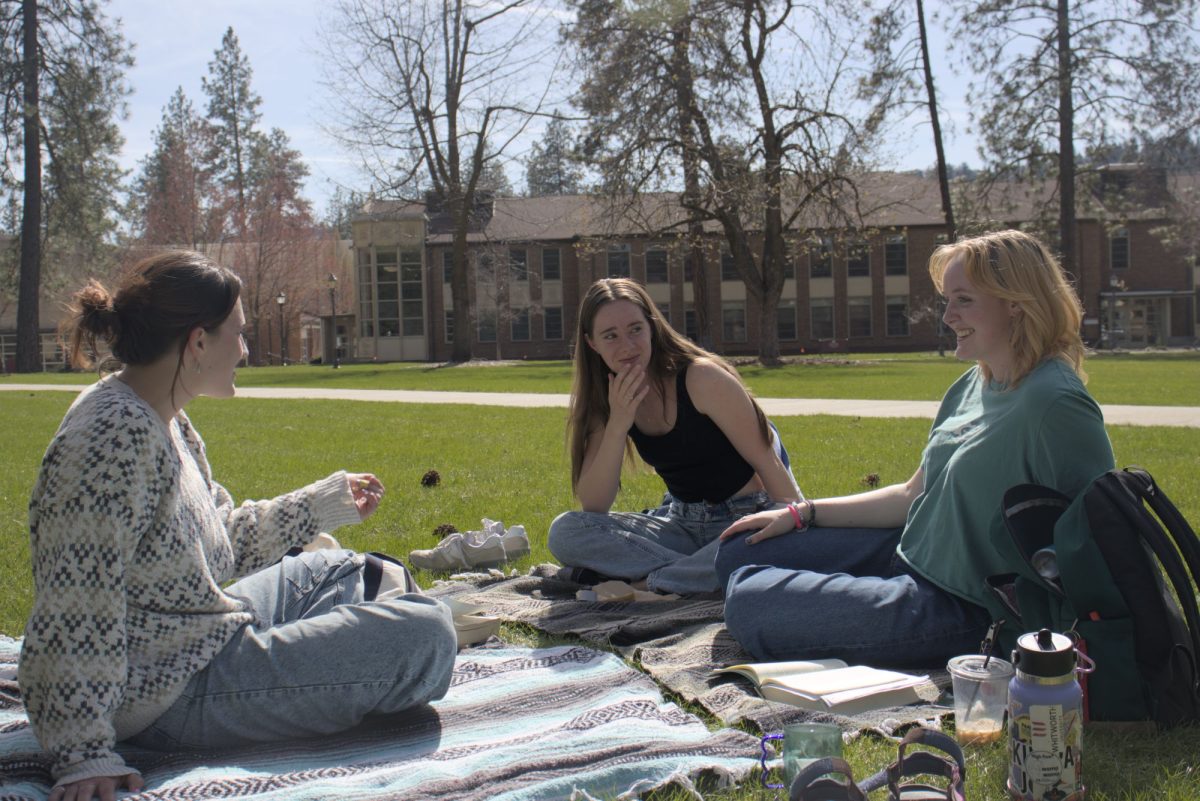 From left, Phoebe Birchfield, Savana Roscoe and Dara Wiebe have a picnic and study session in The Loop, Monday, April 14, 2025, at Whitworth University in Spokane, Wash. | Kiernan Martin/The Whitworthian