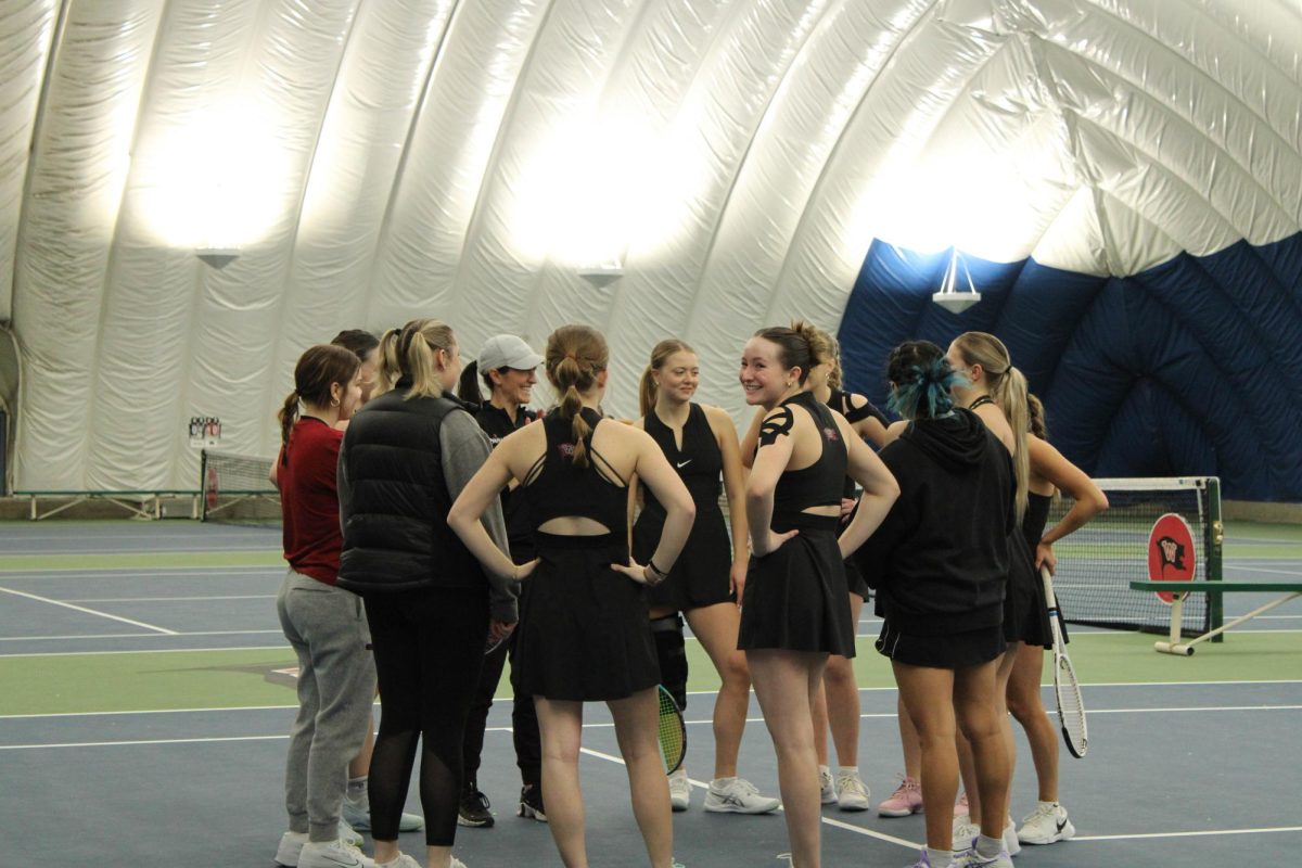 Olivia Corbett in a team huddle before a tennis match at Whitworth University, Saturday, Feb. 22, 2025, in Spokane, Wash | Mikaela Butlay/The Whitworthian