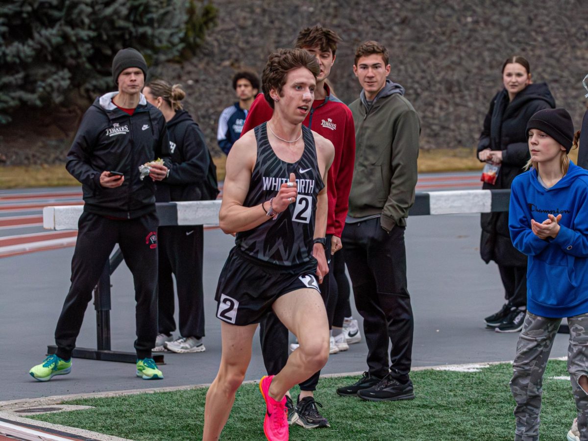 Whitworth runner London Haley continues a race as fans cheer, Friday, April 4, 2025, at the Whitworth Track in Spokane, Wash. | Photo by Jack Tenold/The Whitworthian