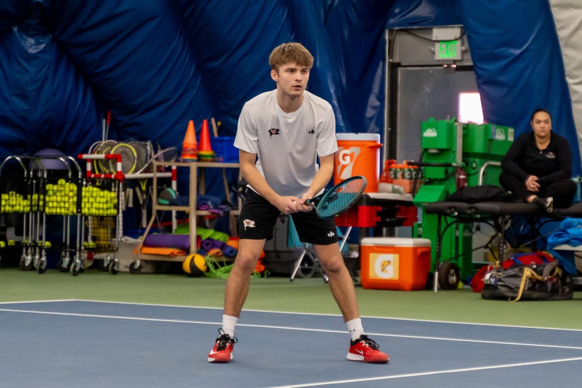 Henry Preacher prepares to intercept an opposing serve, Sunday, March 16, 2025, at an NCAA Men's Tennis match against Whitman College at the Whitworth Tennis Bubble in Spokane, Wash. | Caleb Flegel / The Whitworthian