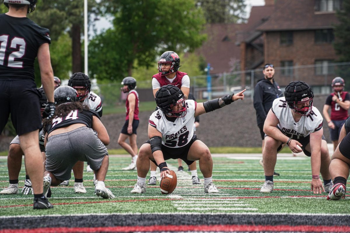 Caleb Cabrera (58) prepares to snap the ball to Logan Lacio (7) during Whitworth Football's Spring Fling, Saturday, May 3, 2025, in Spokane, Wash. | The Whitworthian/Kaiden Devereaux