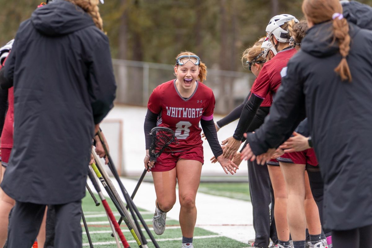 Whitworth midfielder #8 Peyton Green runs past teammates onto the field, Saturday, March 15, 2025, at an NCAA Women's Lacrosse game against Whitman College at the Whitworth Pine Bowl in Spokane, Wash. | Caleb Flegel/The Whitworthian