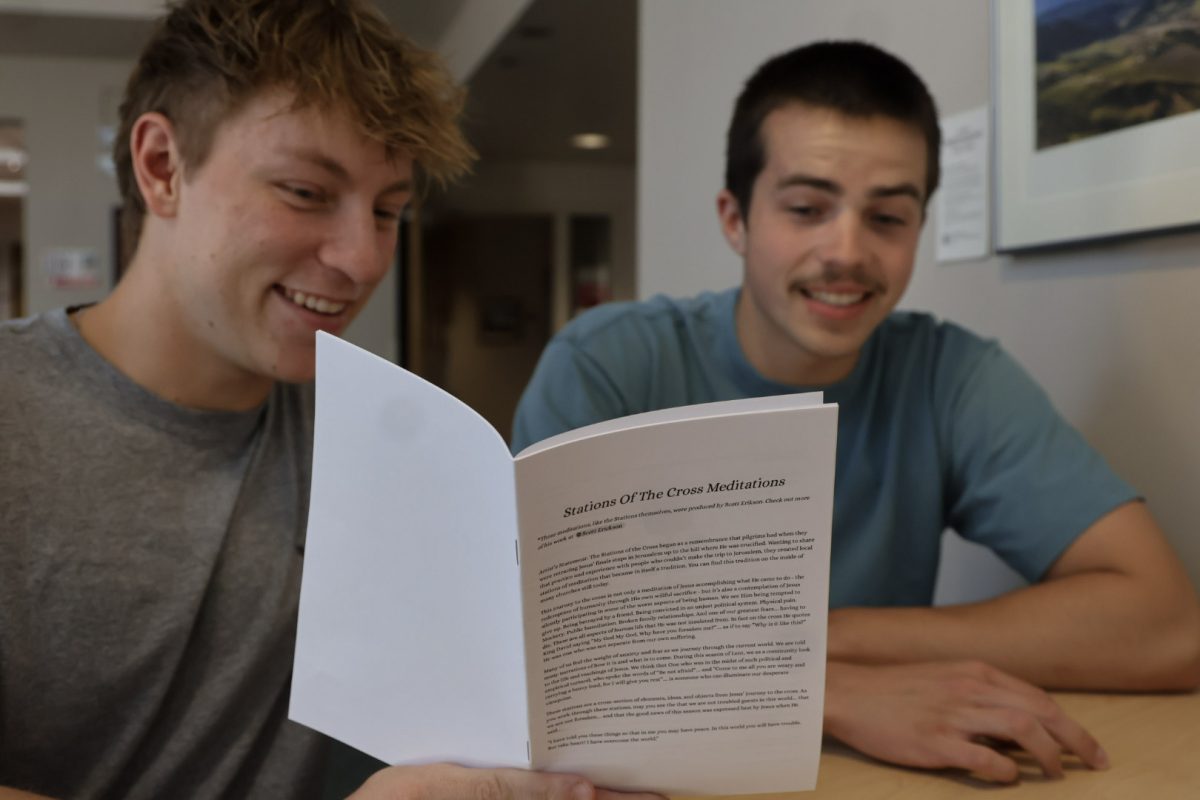 Matt Hossack (left) and Connor Sweeney (right) meditate on The Stations Of The Cross inside the Hixon Union Building at Whitworth University, Monday, May 4, 2025, in Spokane, Wash. | The Whitworthian/Riley Brubaker